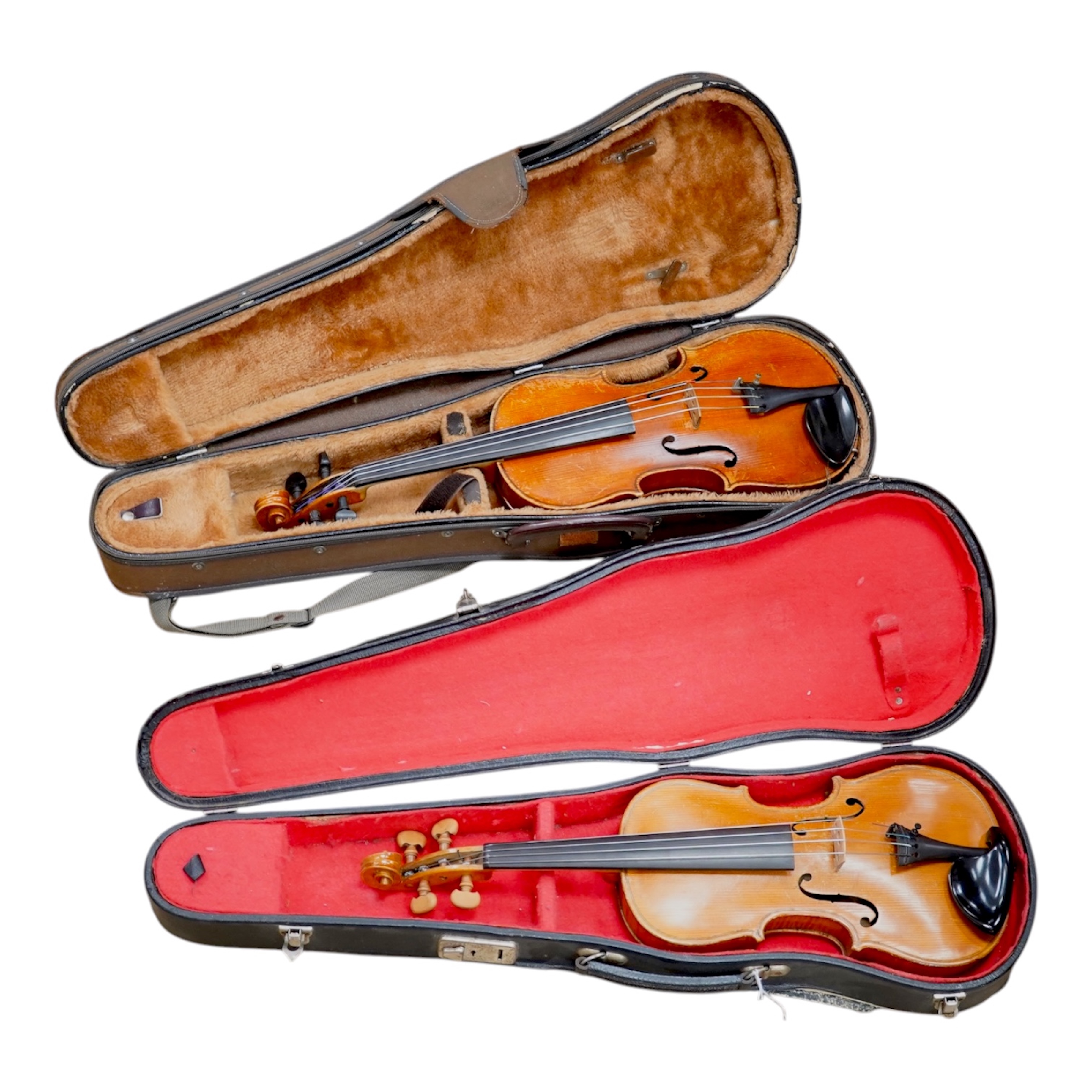 Two cased three quarter size violins, one labelled the London violin Co Ltd, length of back 33.5cm. Condition - both scratched